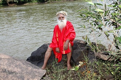 Swamiji sitting on the rock by the Barvi river where he did Lalitha Sahasranam with water